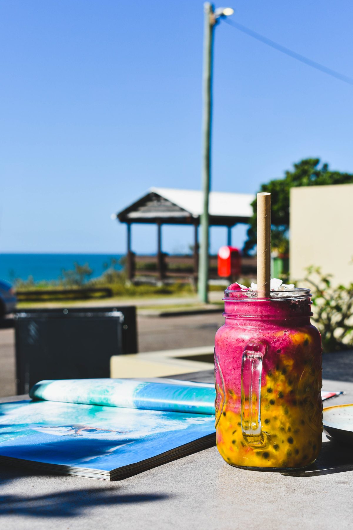 Layered smoothie with the beach behind