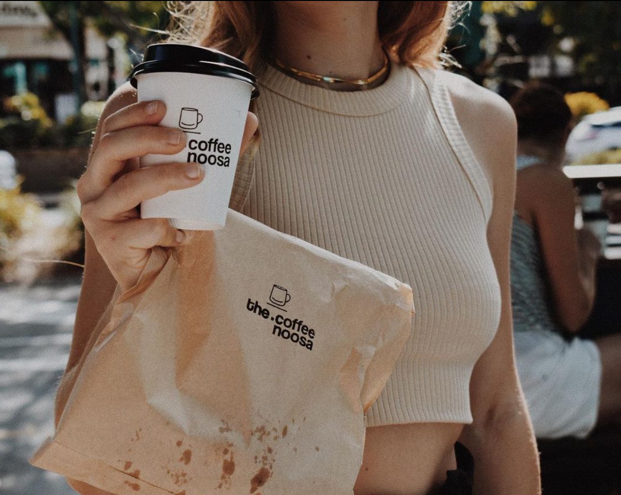 The Coffee Noosa branded cup and paper bag