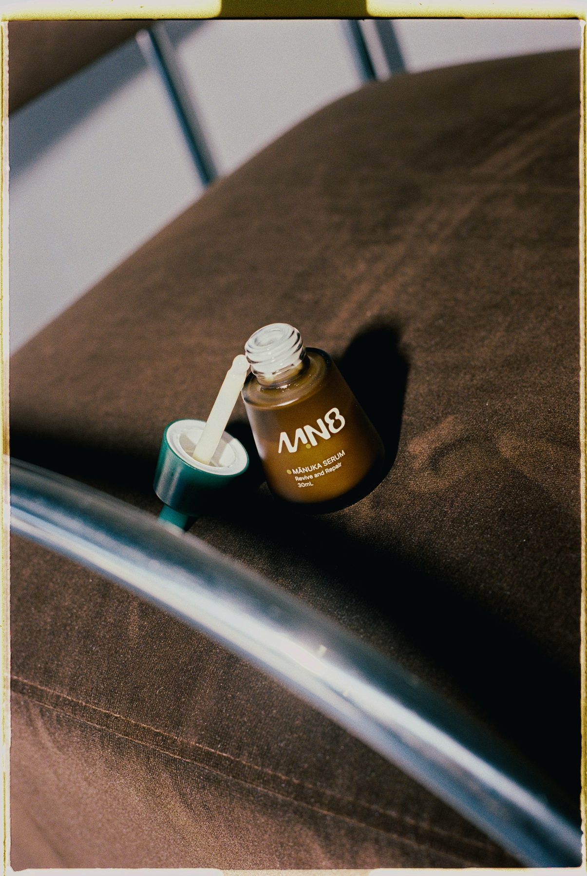 MN8 serum on a velvet couch