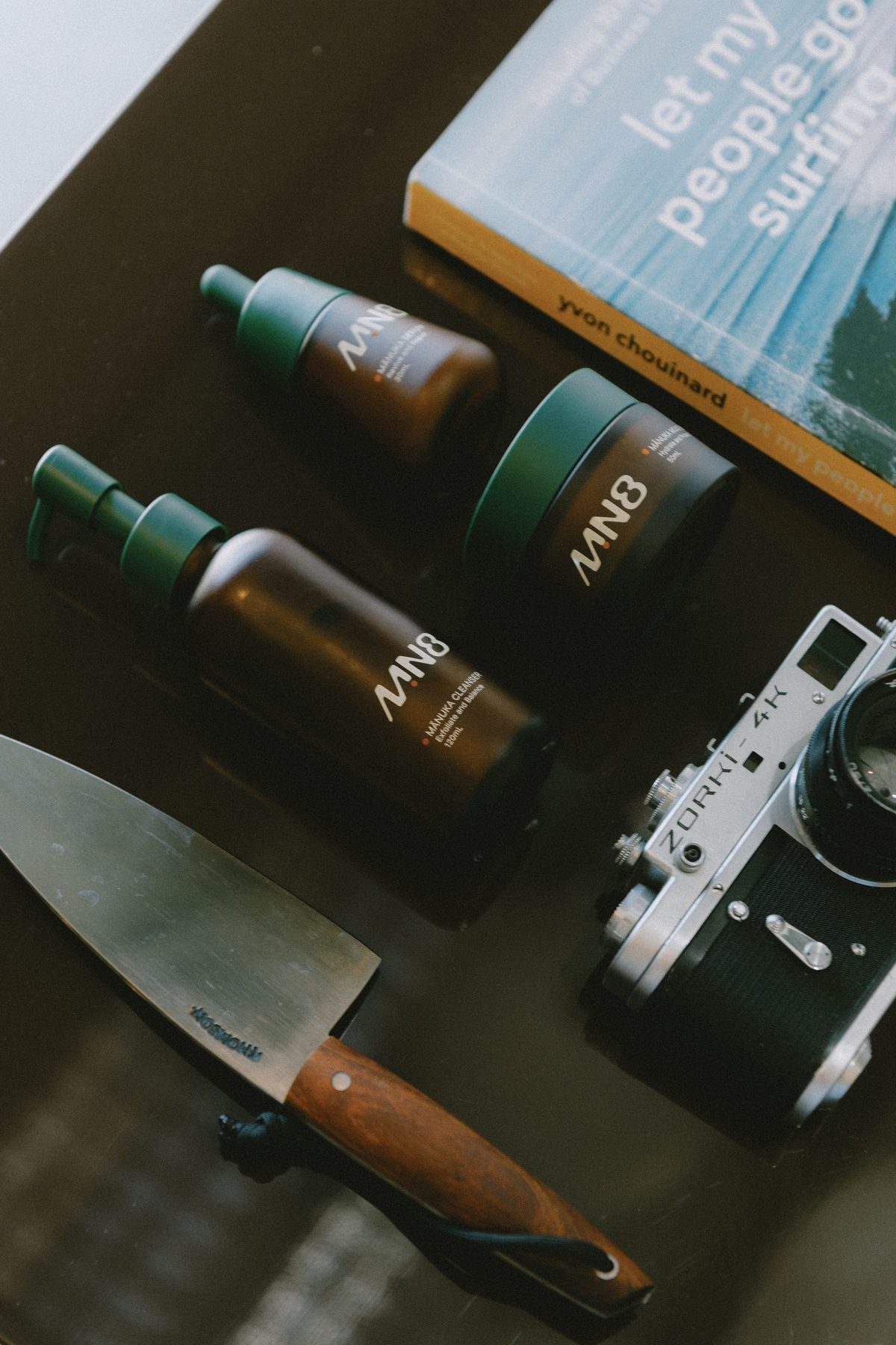 MN8 products styled with a book and film camera