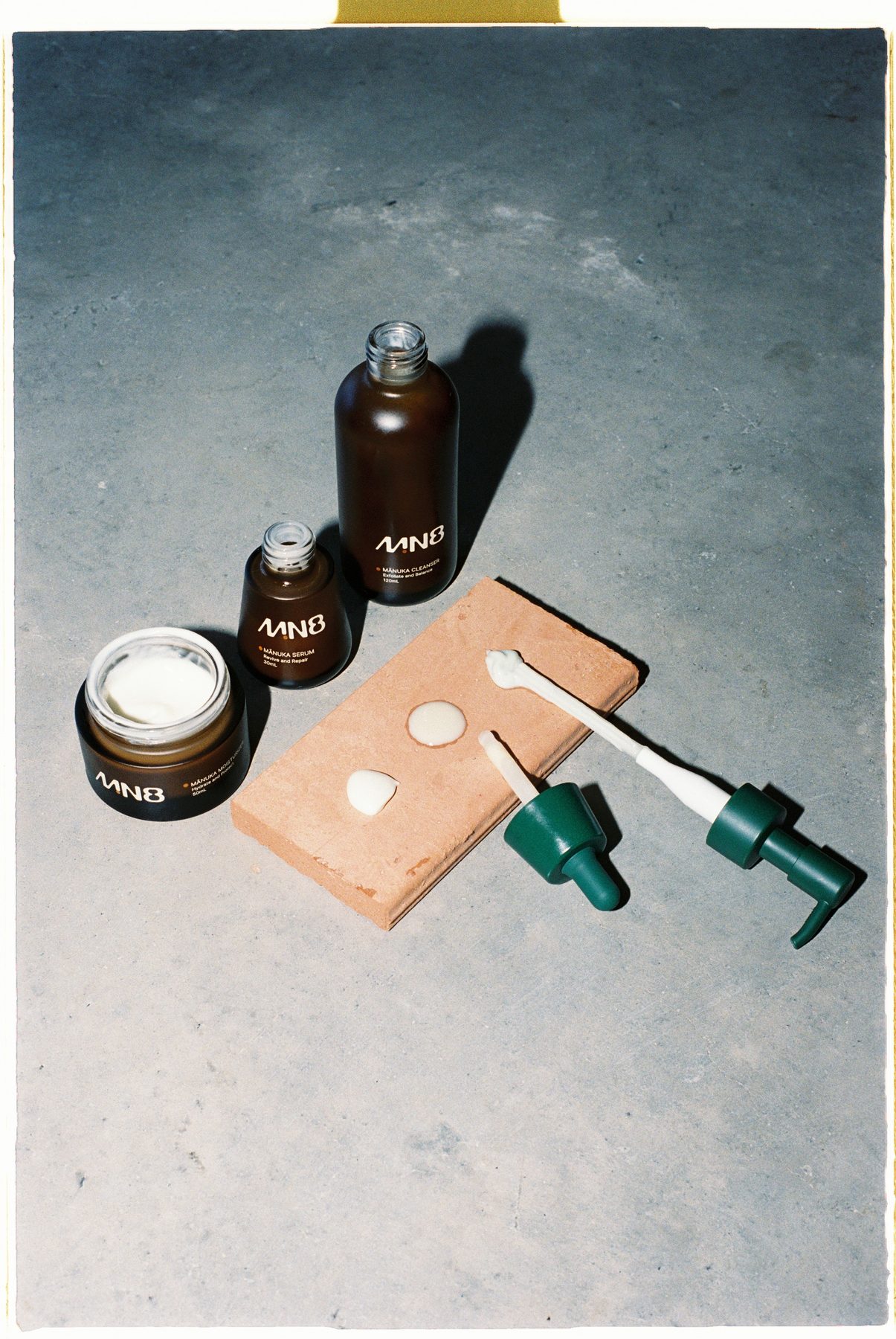 MN8 cleanser, serum and moisturiser on concrete