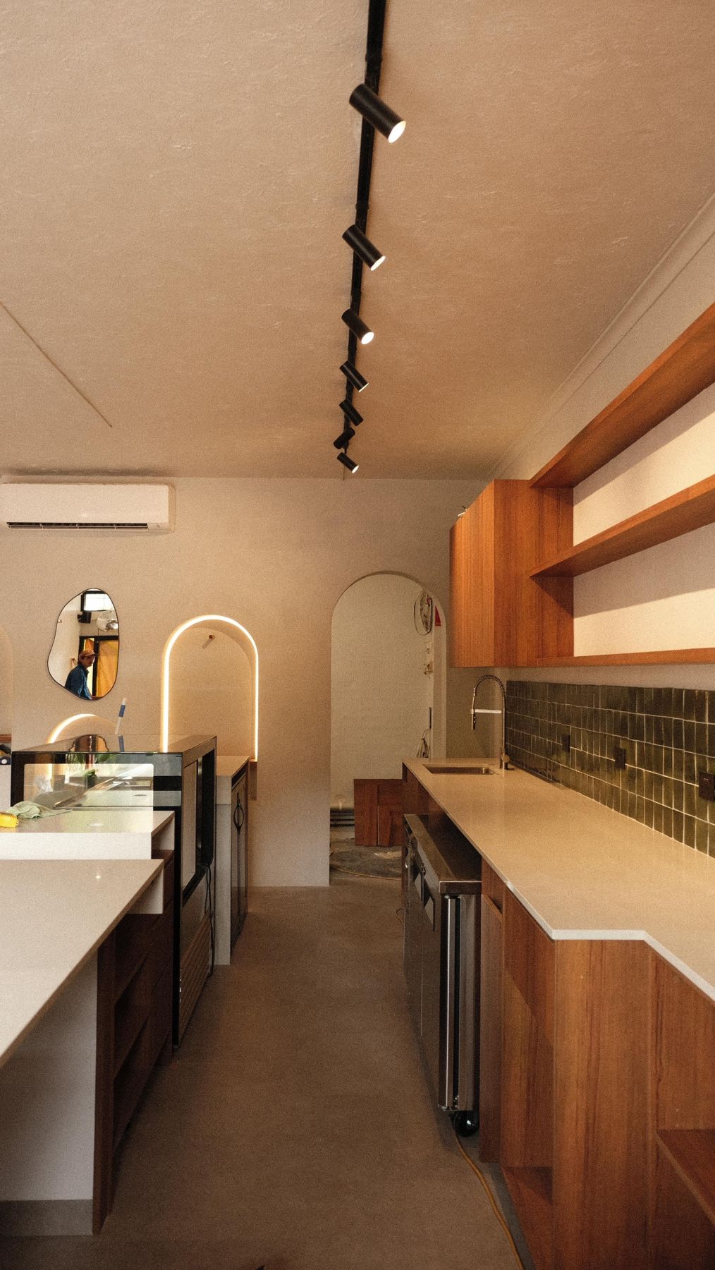 Timber joinery, green tiles and lit arches along the new Coffee Noosa counter
