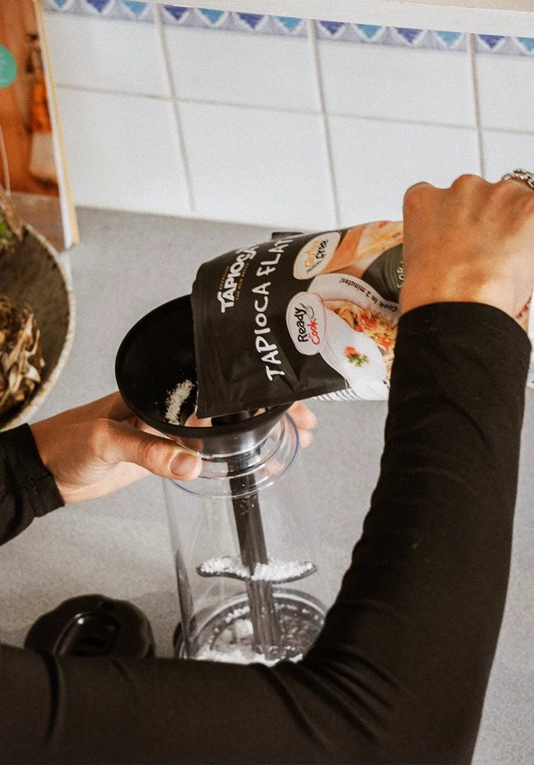 Pouring tapioca flour into the Tapioca Maker