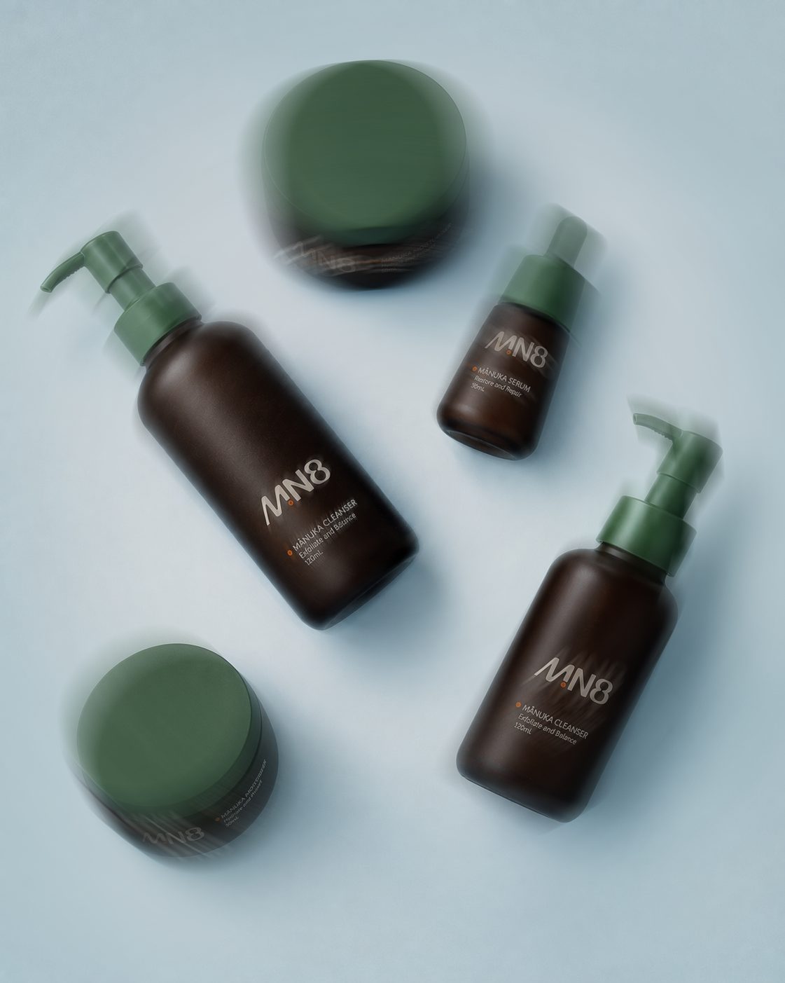 MN8 products in motion on a pale blue background