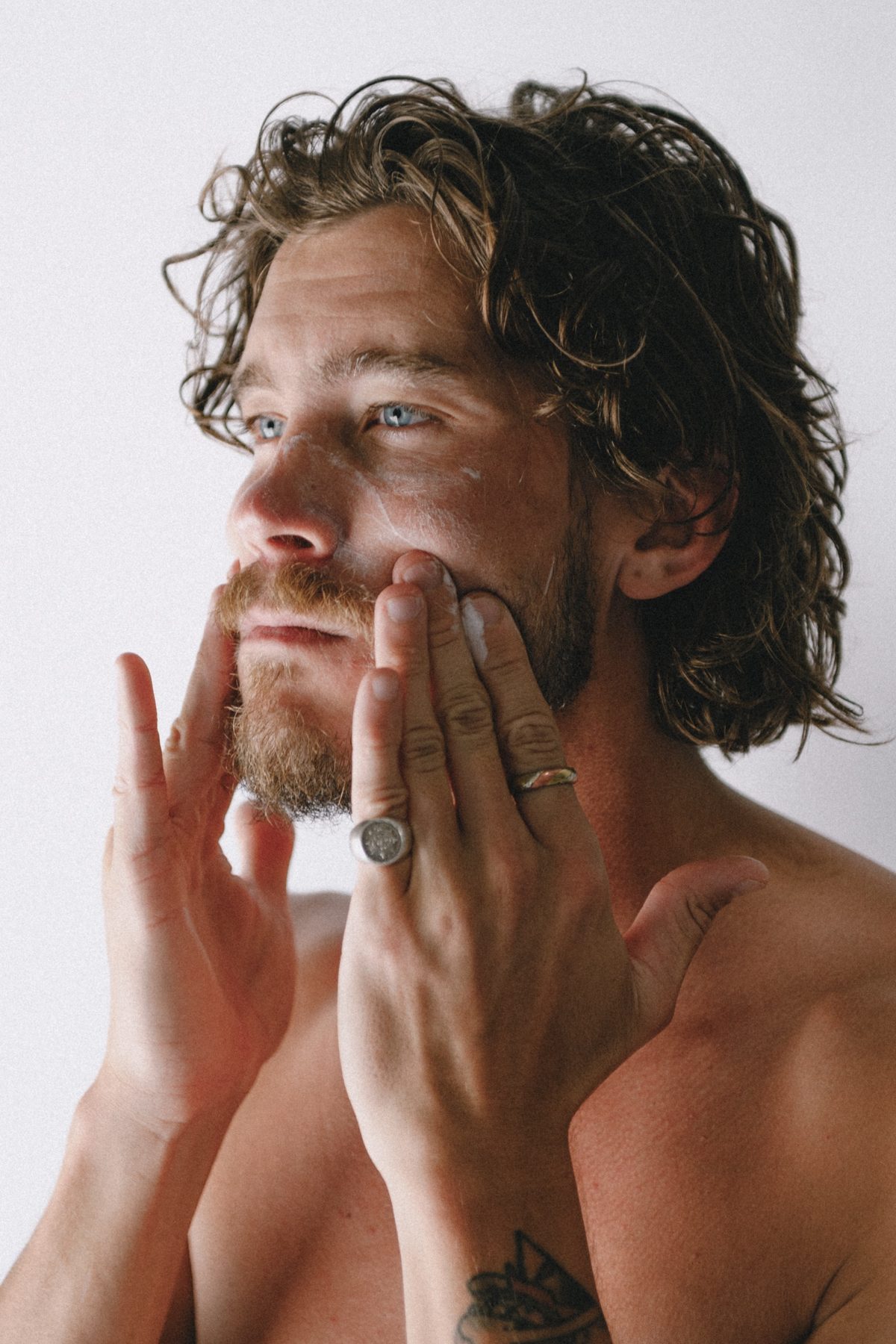 Man applying MN8 Skincare moisturiser